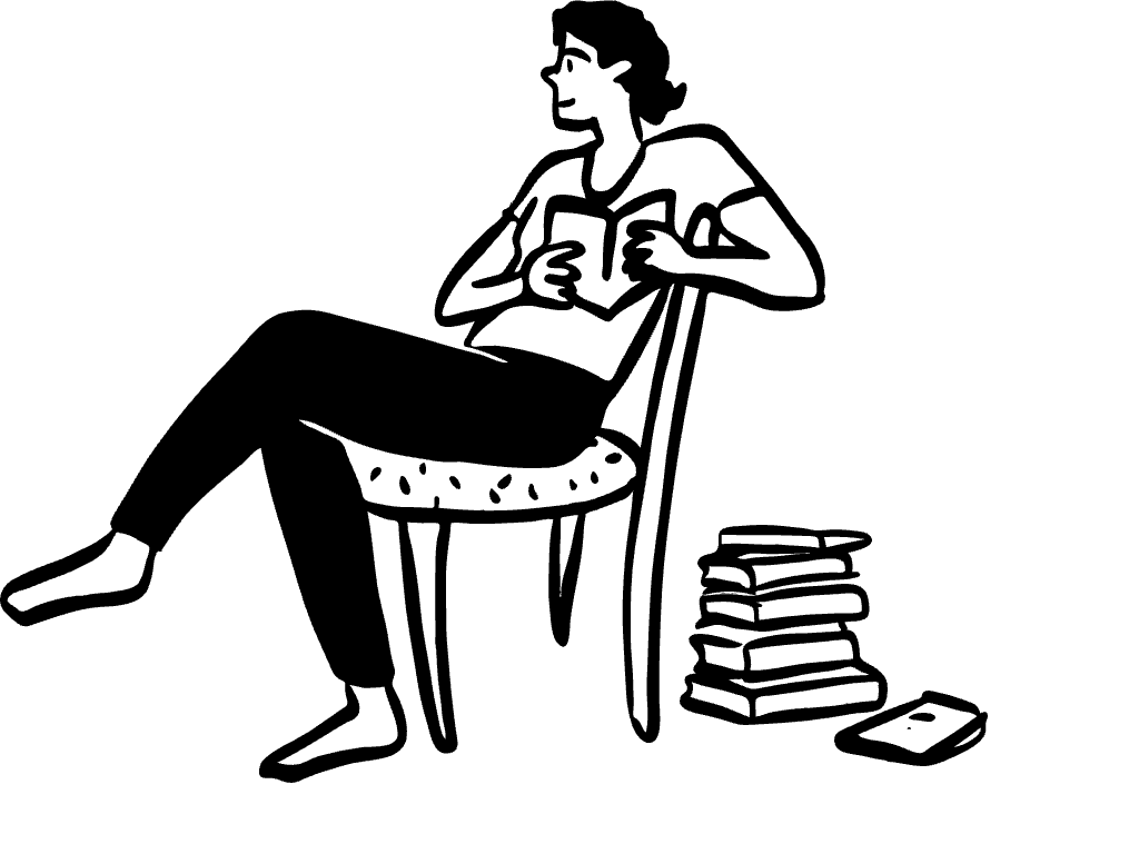 Person sitting on chair reading book